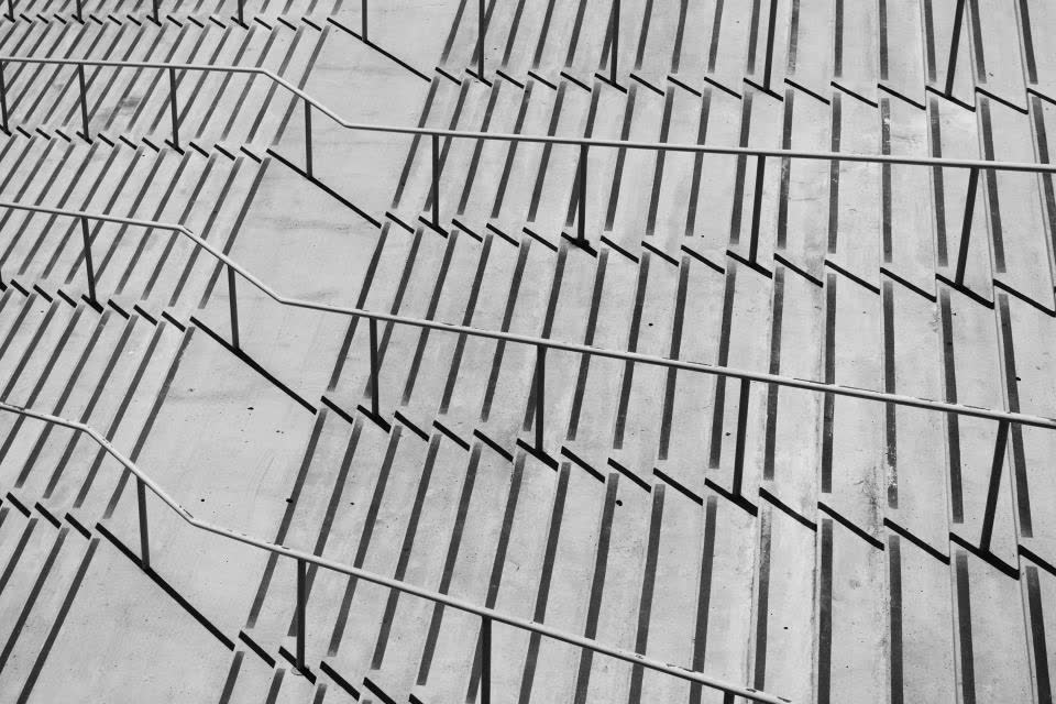 Hollow House, plate 4: Concrete steps and handrails casting long parallel shadows